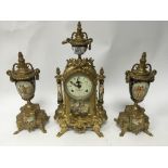 A gilt brass serves style porcelain clock garniture.