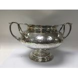 A arts and crafts style silver bowl with stylised