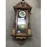 A oak cased musical wall clock