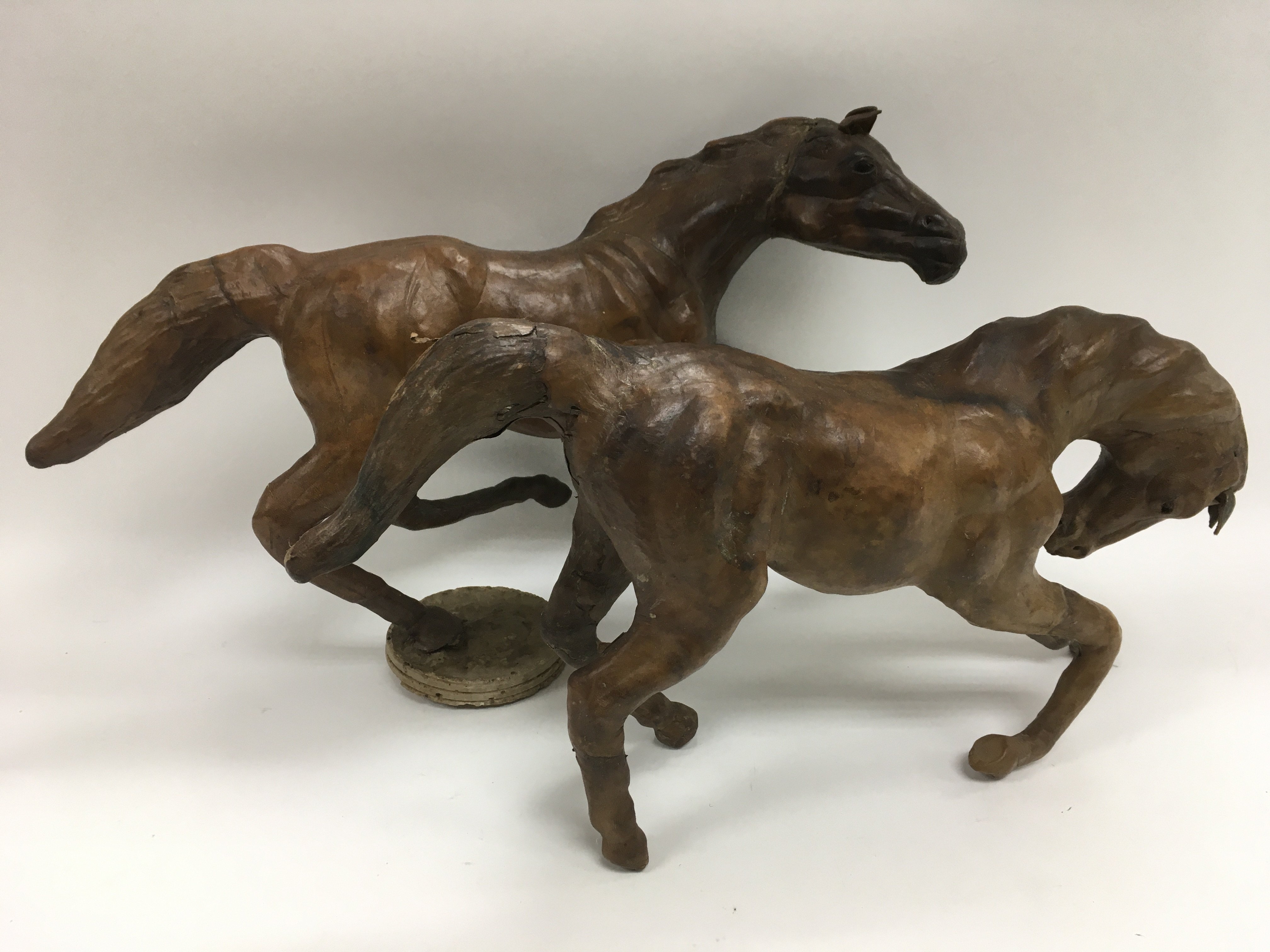 Two leather models of horses.