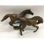 Two leather models of horses.