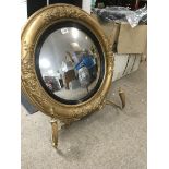 A Georgian gilt framed circular wall mirror with applied candle holders .