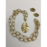 An 18ct gold designer necklace and pair of earring