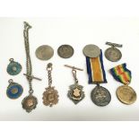 A group of gold and silver fobs, medallions and WW