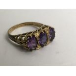 A 9ct gold ring set with three amethysts.Approx P