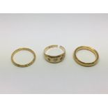 Three gold rings, one set with three small diamond