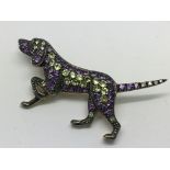 A dog brooch set with peridots, amethysts and diam