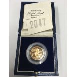 A 1984 cased proof half sovereign.