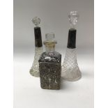 Two glass perfume bottles with silver collars and