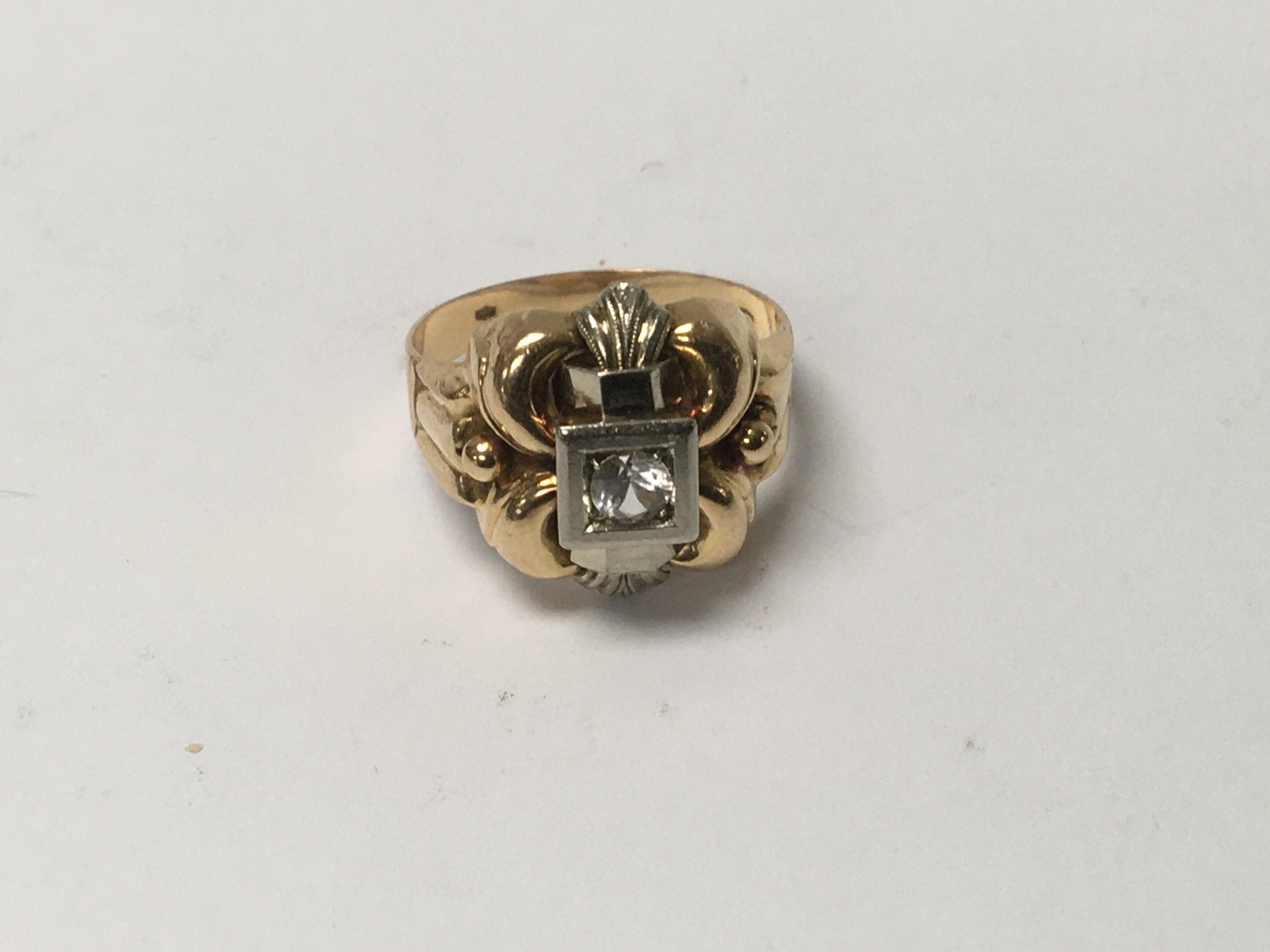 A gold ring of Victorian design inset with a singl