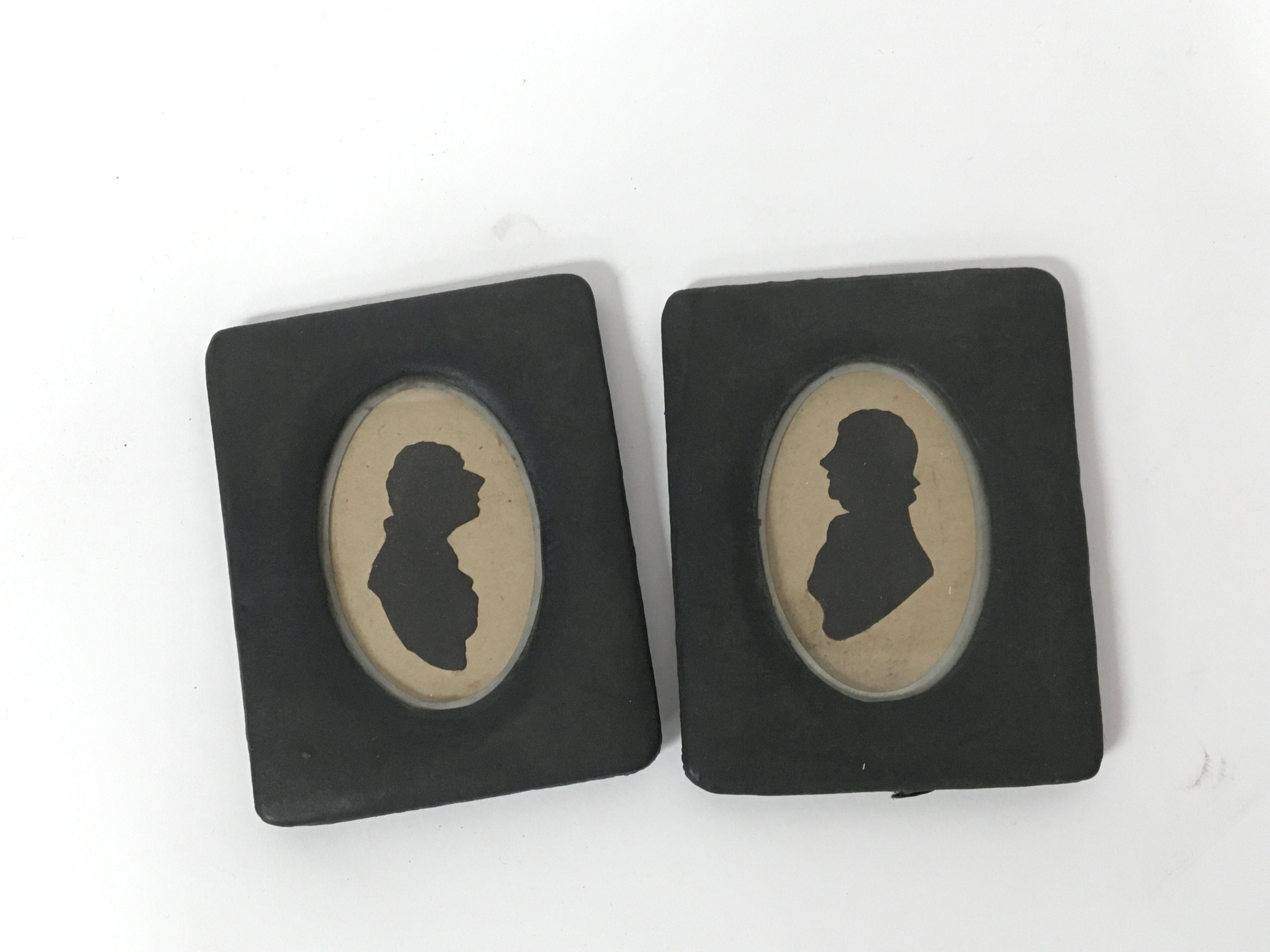 A pair of silhouettes of a man and woman in stand