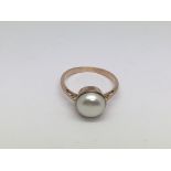A 9ct rose gold ring set with a pearl, approx 2.9g