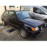 A Ford Fiesta S Car finished in black with red trim front spot lights and rear spoiler.1600 cc