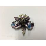 A silver and enamel orchid brooch.