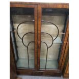 A walnut Art Deco display cabinet the double doors enclosing glass selfs . 78 by 120 cm