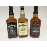 Three bottles of Jack Daniels Tennessee Whisky Old no 7 and Tennessee Honey all one litter bottles .