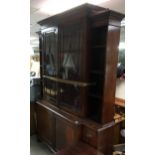 A large, George III style reproduction breakfront bookcase with cupboard base and side drawers