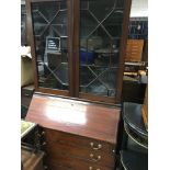 A Edwardian mahogany inlaid bureau bookcase the pair of glazed doors above a fall front with four