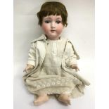 A German bisque headed doll with impressed marks for A.M.