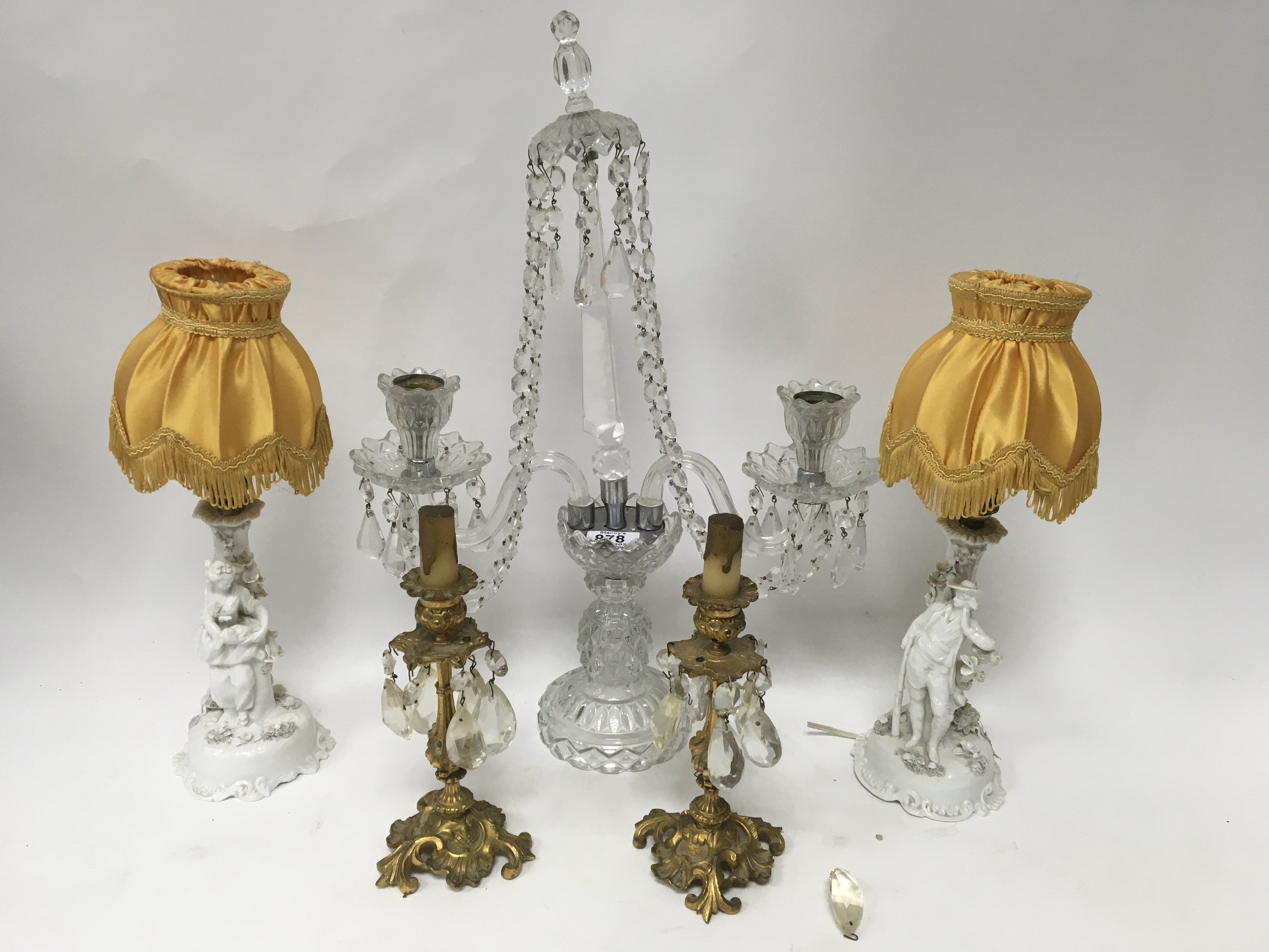 A pair of German White porcelain figural lamps, a pair of gilt brass candlesticks and a glass