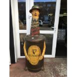 A rare and unusual Guiness advertising figure in the form of a Guiness bottle with a gentleman's