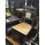 A late Victorian oak hall chair inset with a decorative tile.