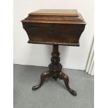 A Victorian bur walnut teapoy the hinged lid enclosing a fitted interior on turned column and