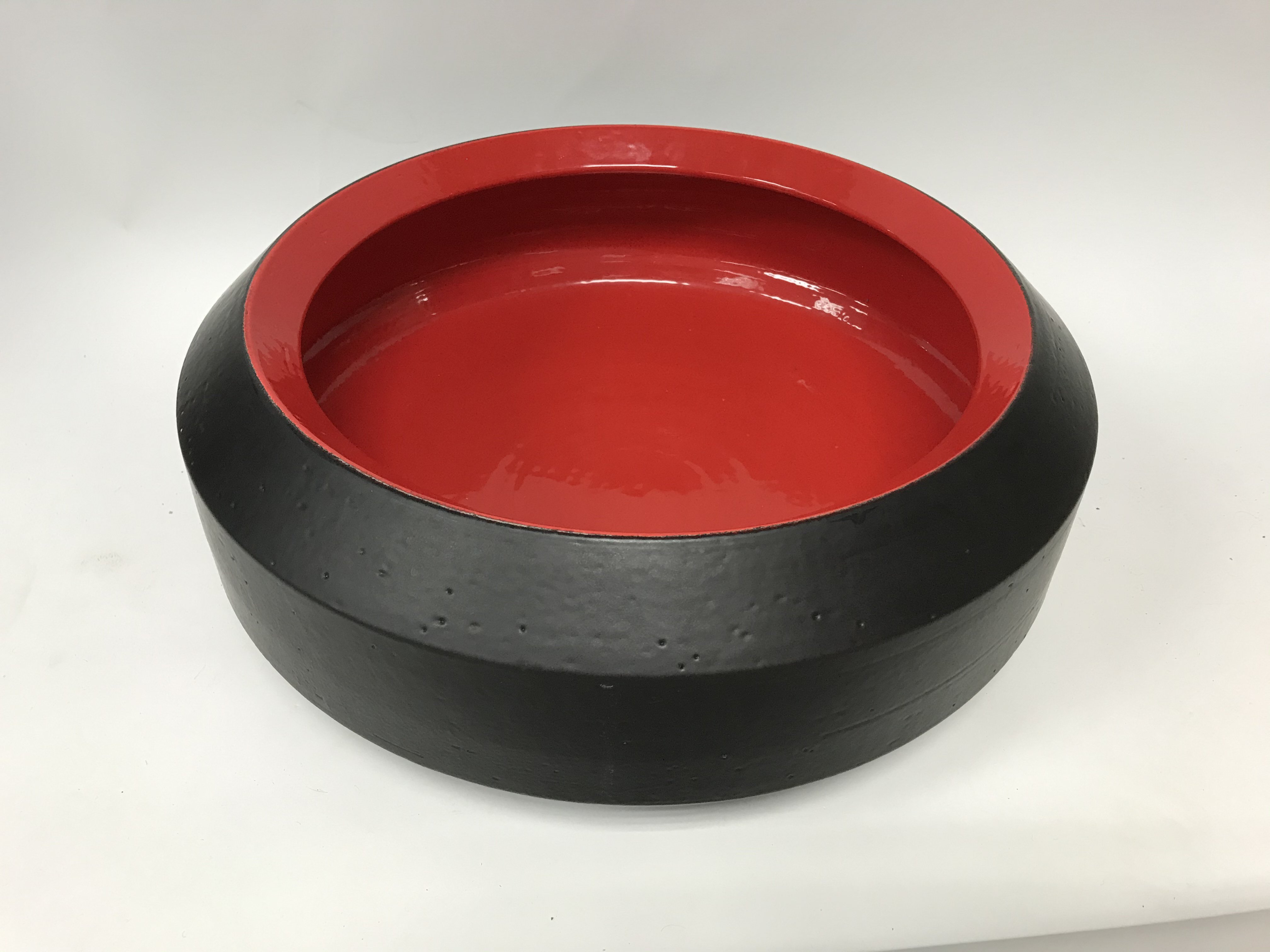 A large 1970s/80s black and red Bitossi ceramic studio pottery bowl by Aldo Londi.