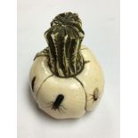 A small carved ivory vegetable with shubiyama style insect decoration.