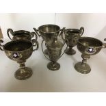 A collection of six small silver trophy cups.