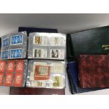 A collection in nine albums of various sets of playing card plus a an album of vintage postcards -