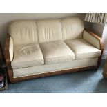 A Quality Art Deco three piece suite with cream leather upholstery with shaped walnut polished