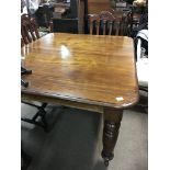 A large Victorian extending wind out dining table with 2 additional leaves.