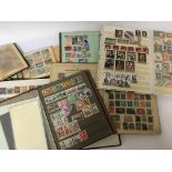 A collection of stamp albums containing world stamps mainly used stamps some early 20th Century