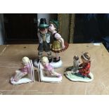 A 1950s Austrian pottery figure of children, child bookends and a Goebels figure.