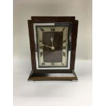 An Art Deco design walnut veneered mantle clock by