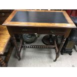 A small Edwardian desk the rectangular top above two drawers turned legs united by a stretcher.44 by