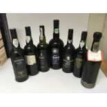 A collection of seven bottles of port .