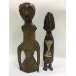 An East African carved wooden Nyamwesi seated figure, 31cm with an additional African carved