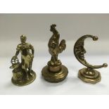 Three brass car mascots comprising a cockerel, blacksmith and a crescent moon, tallest approx 15cm -
