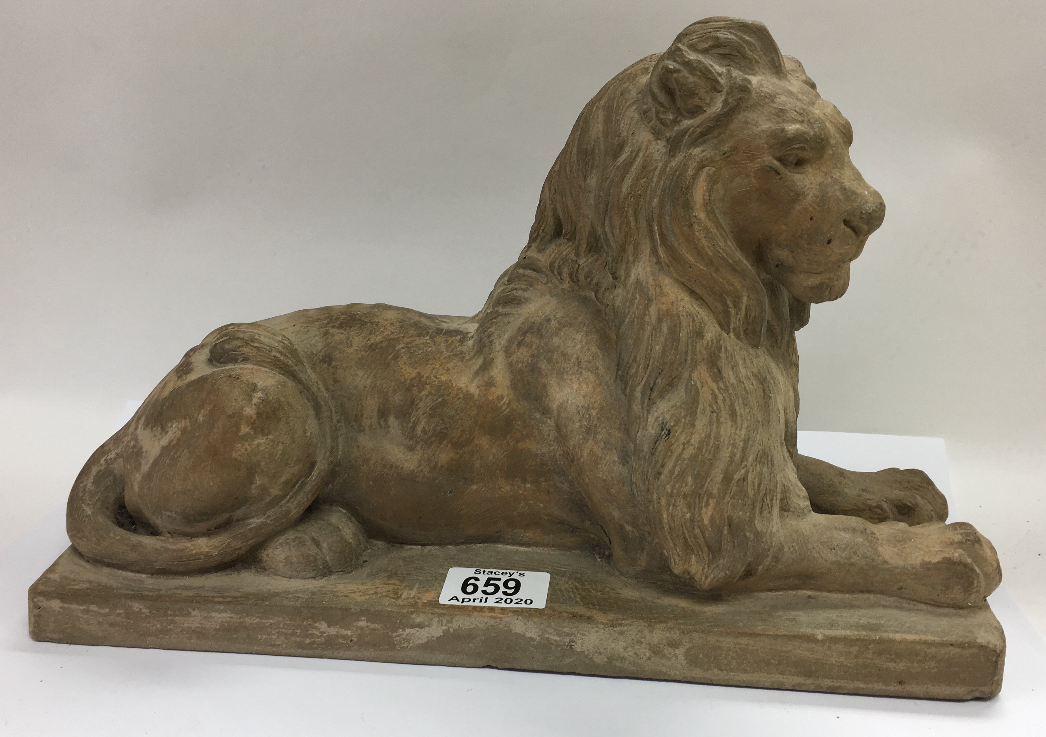 A Signed terracotta sculpture of a resting lion in the style of Landseer c1850. 34.5cm