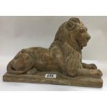 A Signed terracotta sculpture of a resting lion in the style of Landseer c1850. 34.5cm
