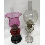 A cut glass oil lamp and a ruby glass oil lamp.