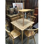 A light elm and oak Ercol kitchen table with four