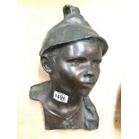 A bronze bust of a young boy, signed. 31cm.