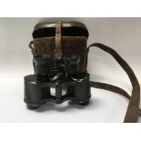 A leather case containing field glasses by Rench and sons with provinces