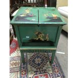A sewing box decorated with oriental design the enclosed lid with a fitted interior and drawer under