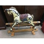 A vintage painted rocking horse. 90cm x 100cm