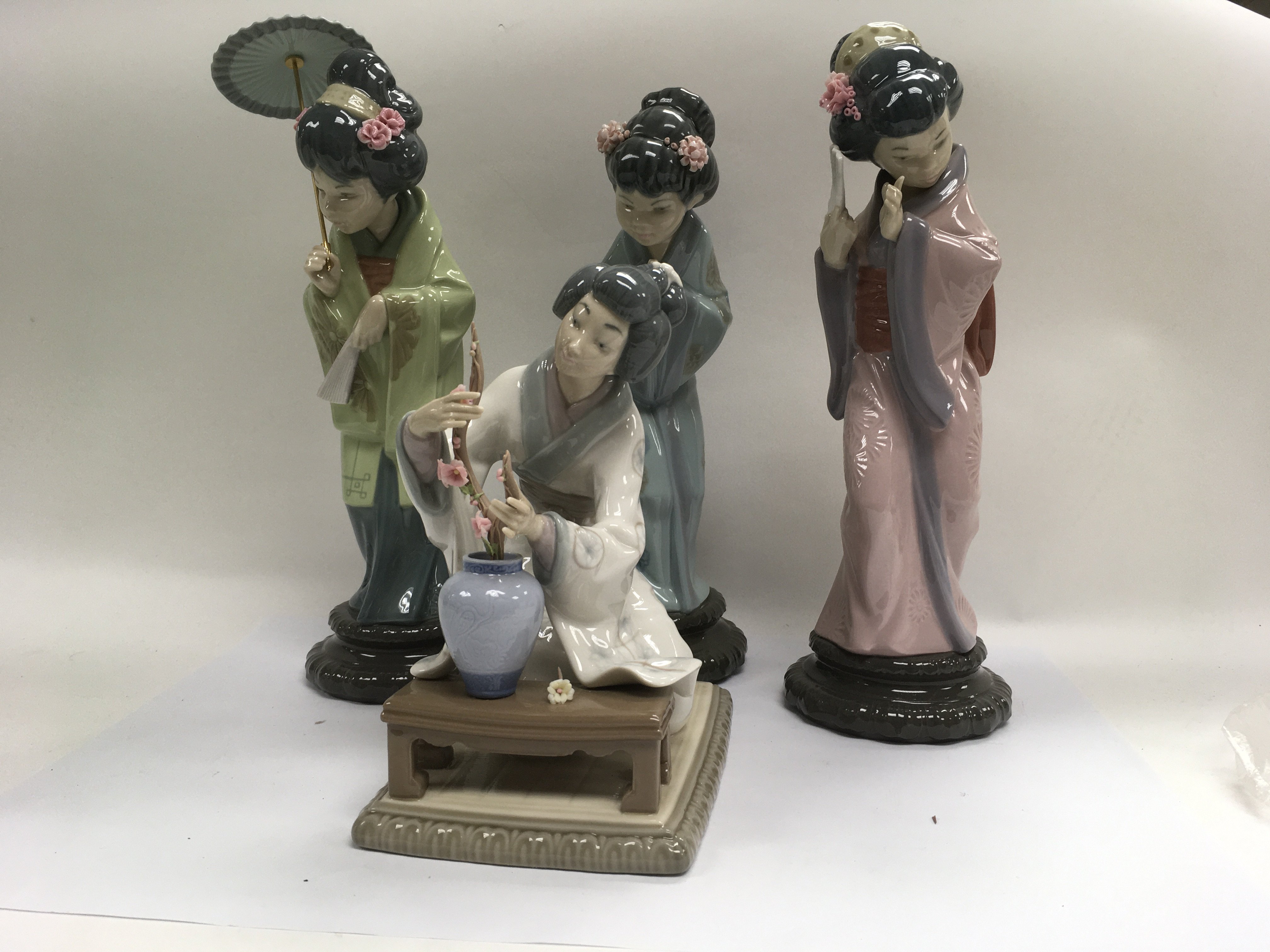 A collection of four Lladro figures in the form of no damage or restoration