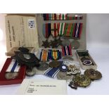A collection of medals badges and ribbons. To inc.
